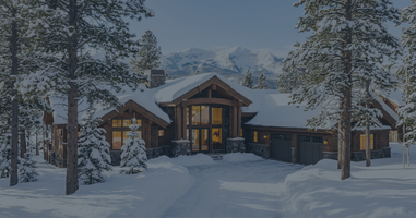 A stunning luxury log home in Pagosa Springs covered in winter snow, located just a short drive from Wolf Creek Ski Area.